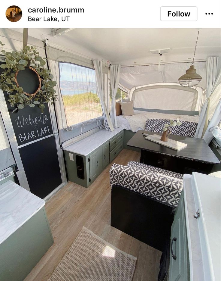 the interior of a camper with lots of storage space and furniture in front of it