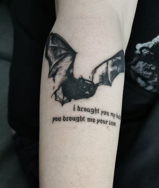 a woman with a bat tattoo on her arm that says, i brought you home