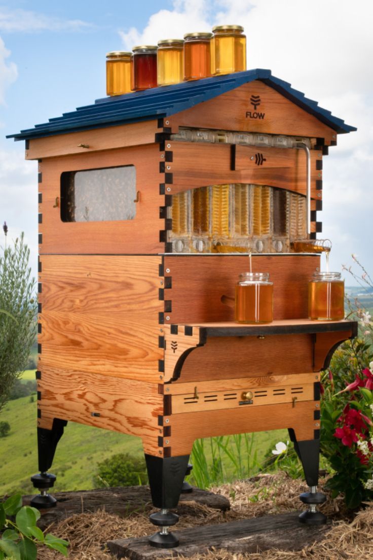 a beehive made out of wood with honey jars on top