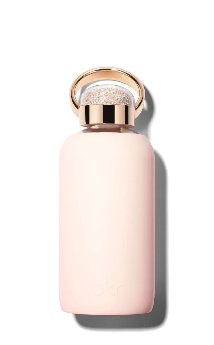 a pink bottle with a gold ring on the top