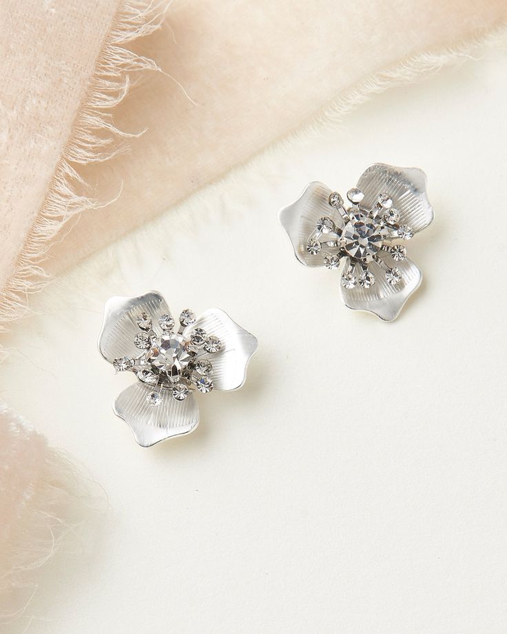 KACIE FLORAL BRIDAL STUDS (JE-4198) Soft florals & shimmering crystals make our Kacie Floral Bridal Studs the perfect accent to your wedding day style. Crafted with petals & round gemstones, you'll want to wear Kacie again & again, long after you say 'I do.' DETAILS * Handcrafted with metal leaves & florals, round crystal gemstones. * Measures .75 inches. * Finishes: silver, gold & rose gold. * Lightweight for easy day to night wear. SHOP MORE STYLES https://www.etsy.com/shop Wedding Clip-on Flower Earrings, Elegant Flower-shaped Clip-on Earrings For Wedding, Elegant Flower Shaped Clip-on Earrings For Wedding, Flower Shaped Clip-on Earrings For Wedding, Elegant Flower Clip-on Earrings For Wedding, Silver Flower Shaped Clip-on Earrings For Party, Silver Flower-shaped Wedding Earrings, Silver Flower-shaped Earrings For Wedding, Elegant Silver Flower Earrings For Wedding