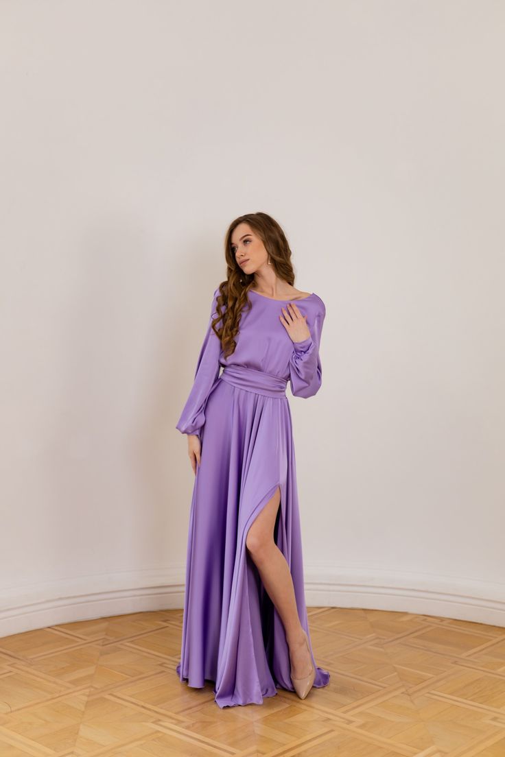 Look exquisite at any wedding or evening party in this elegant purple satin dress. Made with a luxurious silky satin fabric, this dress features boat neckline and V-open back design with an elastic waist for a comfortable and flattering fit. You'll love the separate sash that adds a touch of sophistication to this dress with long sleeves. This dress is custom-made according to your measurements, so please be sure to leave all necessary measurements in the "Personalization" box. Don't know how to Purple Bridesmaid Dress For Prom Evening, Long Sleeve Dresses With Satin Finish For Gala, Long Sleeve Satin Finish Dress For Gala, Purple Evening Dress For Bridesmaid Prom Season, Purple Evening Dress For Bridesmaid During Prom Season, Purple Bridesmaid Evening Dress For Prom Season, Elegant Purple Bridesmaid Dress For Wedding, Satin Dress With Fitted Bodice For Wedding Guest, Lavender Dress With Sweep Train For Party