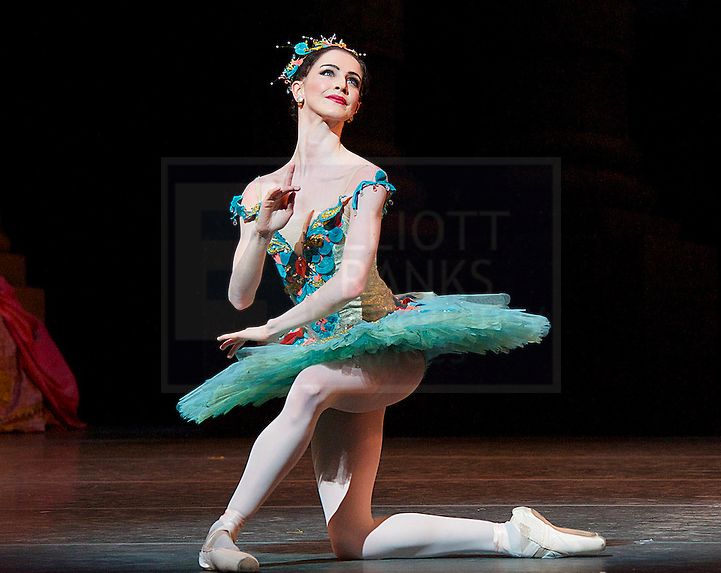 a ballerina is performing on the stage