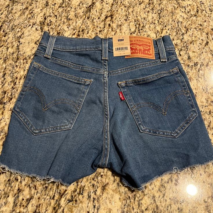 Nwt Levi’s High Rise Shorts Blue Size 24/00. High Rise. Slim Through The Hip And Thigh. Has Stretch. # 3333 *Currently I’m Unable To Provide Any Additional Model Photos Of Myself Due To Medical Condition, Thanks For Understanding!* Check Out My Closet For More Like This! Bundle And Save. Please No Lowballing, No Rude Comments, No Trades Get 20% Off Certain Items With Bundles Of 3 Or More Items!! Only Items With “Get 20% Off“ Apply!!! Levi 501 Shorts, Dark Denim Shorts, High Rise Denim Jeans, Festival Shorts, Frayed Denim, High Rise Denim Shorts, Levi Shorts, Distressed Denim Shorts, High Rise Shorts