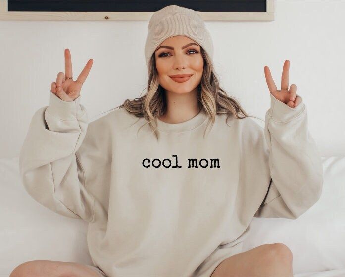 "Funny Mom Shirt | Cool Mama Sweatshirt | Funny Mother's Day Gift *JUST RELEASED* * Custom Design * Limited Edition * *This item is NOT available in stores* Show your Mom love with this custom, limited edition \"cool mom\" sweatshirt.  Ideal for any situation, a unisex heavy blend crewneck sweatshirt is pure comfort. These garments are made from polyester and cotton. This combination helps designs come out looking fresh and beautiful. The collar is ribbed knit, so it retains its shape even after washing. There are no itchy side seams on these sweaters.  .: Made with a medium-heavy fabric blend of 50% cotton and 50% polyester (8.0 oz/yd² (271.25 g/m this sweatshirt feels cozy and is the perfect choice for those colder months. .: The classic fit along with the crew neckline deliver a comfy w Casual Sweatshirt For Birthday And Mother's Day, Casual Slogan Sweatshirt For Mother's Day, Casual Mother's Day Slogan Sweatshirt, Cotton Sweatshirt For Birthday In Winter, Cotton Sweatshirt For Winter Birthday, Casual Cotton Sweatshirt For Birthday, Winter Cotton Sweatshirt With Funny Text, Casual Winter Birthday Sweatshirt, Casual Tops For Mother's Day Loungewear