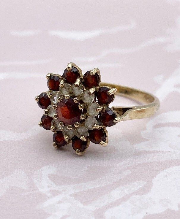 Vintage garnet and clear spinel 9ct gold ring, flower shape, raised setting. UK size N (US small 7). Hallmarked. Vintage Flower Ring With Gemstone, Vintage Flower Shaped Gemstone Ring, Vintage Round Garnet Cluster Ring, Vintage Formal Rings With Flower Shape, Gold Ring Flower, Spinel Ring, Garnet Gem, Ring Flower, Red Band