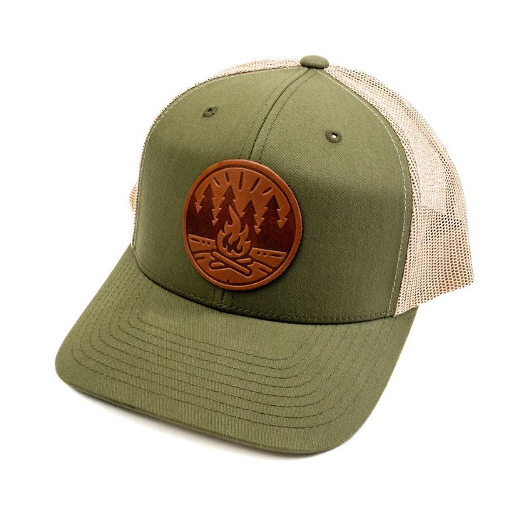 Get Fired Up for Adventure with this Campfire Cap! The patch on this hat features a classic campfire scene, capturing the timeless allure of the great outdoors. It's a simple yet evocative image: two logs ablaze with flames reaching upwards, cradled by a circle that hints at the unity and completeness of nature. The trees standing sentinel on either side anchor the scene in the wild, calling to mind the serenity of the woods and the simple pleasures of a fireside chat under the stars. Each cap i Campfire Scene, Vintage Baseball Cap, Vintage Baseball Caps, Leather Stand, Pocket Notebook, Getting Fired, Vintage Baseball, Mesh Panel, Under The Stars