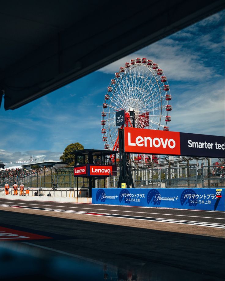 a large ferris wheel sitting on top of a race track