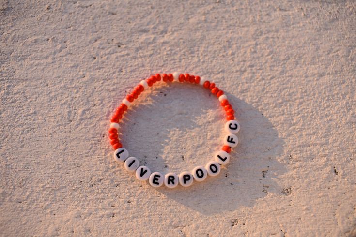 Show your love for Liverpool FC with this vibrant red and white seed bead bracelet. Handcrafted with attention to detail, this stylish accessory features the iconic Liverpool Football Club colors. Whether you're heading to a match or simply want to showcase your team spirit, this bracelet is the perfect way to do it. Made with high-quality materials, it's comfortable to wear and adds a pop of color to any outfit. Get ready to cheer on your favorite team in style with this Liverpool FC seed bead bracelet! Purple Envelope, Fc Liverpool, Club Color, Seed Bead Bracelet, Liverpool Football Club, Liverpool Football, Seed Bead Bracelets, Custom Bracelets, Liverpool Fc