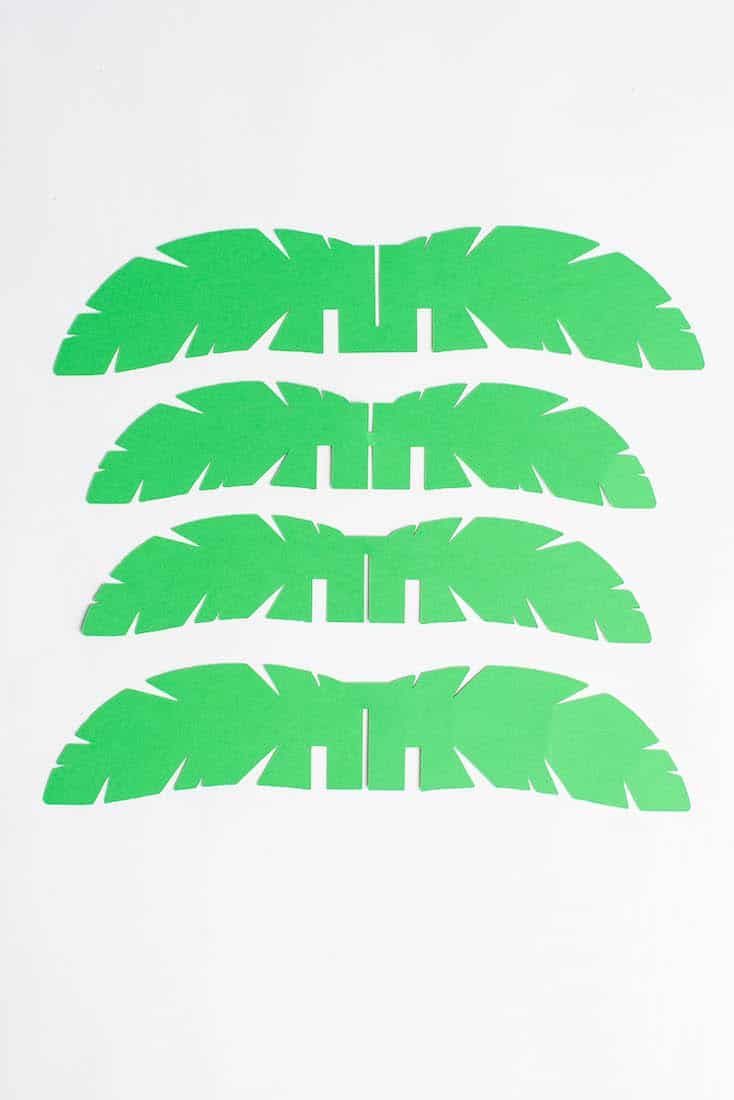 three pieces of green paper cut into four different shapes with the same length as each other