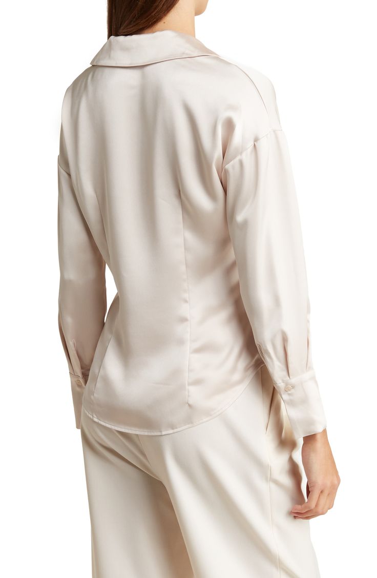 Sleek satin adds liquid shine to a button-up shirt framed by long sleeves for comfort during cooler temps. 27 3/4" length Front placket V-neck Spread collar Long sleeves with button cuffs 95% polyester, 5% spandex Hand wash, line dry Imported