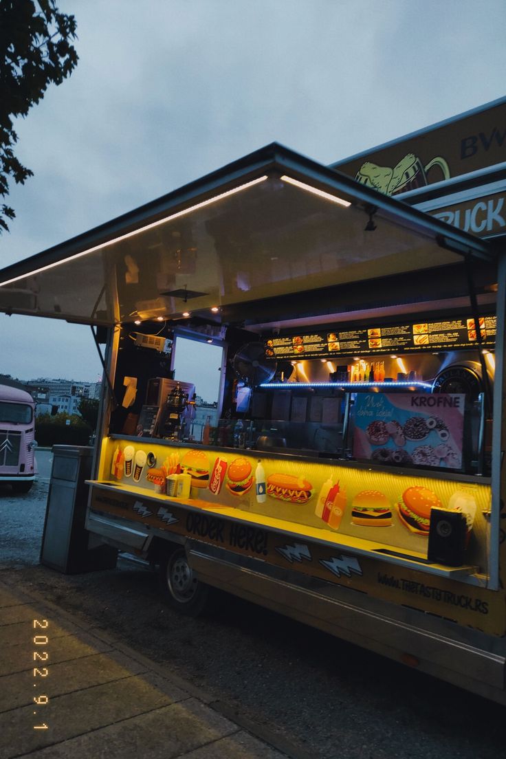 the food truck is parked on the side of the road