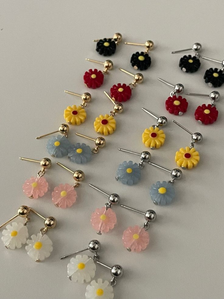 Fun, quirky, and full of personality - these acrylic resin dangle earrings feature charming daisy flowers and come in your choice of gold or silver earring posts. Choose your preferred flower dangle color to add a touch of playfulness to any outfit.- Stainless steel, Acrylic Resin- Daisy: 10x10mm- Stud ball: 4.8mm Dangle Flower Earrings With 3d Flowers, Trendy Silver Flower Earrings, Trendy White Earrings With Flower Charm, Cute Silver Flower Earrings, Trendy 3d Flower Earrings, Dainty 3d Flower Earrings, Trendy 3d Flower Jewelry, Cute Daisy Shaped Flower Earrings For Gifts, Cute Daisy Flower Earrings For Gift