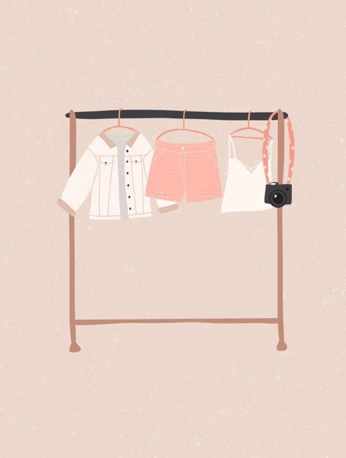 clothes are hanging on a rack in front of a wall with a pink and white background