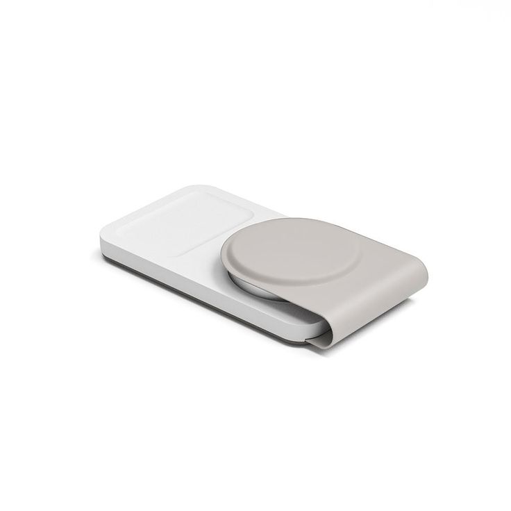 an electronic device with a button on the front and back side, sitting on a white surface