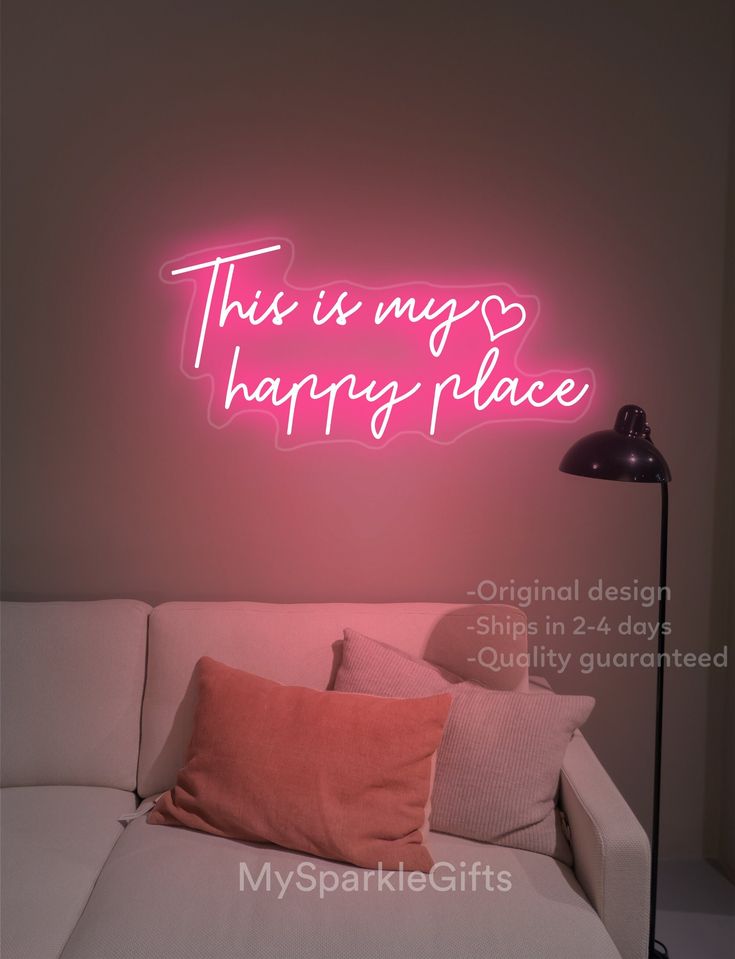 this is my happy place neon sign on the wall above a couch in a living room