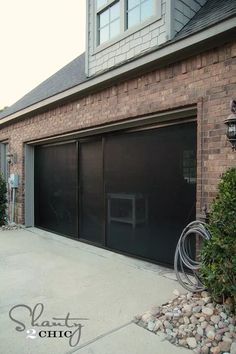 a brick building with two garage doors on the side