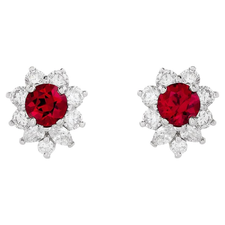 Illuminate your style with the captivating brilliance of Tiffany & Co.'s bright red ruby earrings. Set in platinum, these exquisite gems are embraced by a sparkling diamond halo, evoking a timeless elegance that exudes sheer sophistication. The two red rubies are round shape, and weigh approximately 1.20 total carats. There are 4 marquise and 14 round diamonds that surround the rubies; they weigh approximately 1.00 total carat and are E-F color with VS clarity. They are stamped "© Tiffany & Co. PT950" Tiffany And Co Earrings Bloomingdale's, Luxury Ruby Diamond Earrings For Anniversary, Red Diamond Earrings, Tiffany And Co Earrings, Red Ruby Earrings, Ruby Earrings Studs, Halo Stud Earrings, Tiffany Jewelry, Halo Earrings Studs