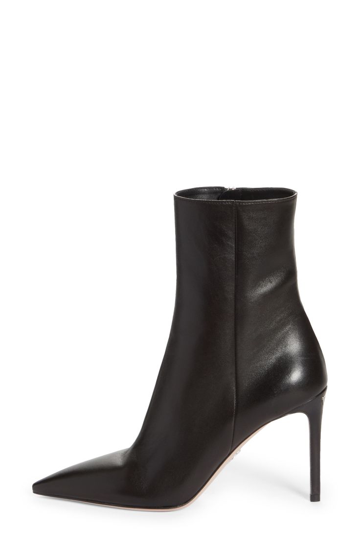 Instantly elevate any ensemble with this sleek and polished boot crafted in Italy from lambskin leather with a seamless front that leads to a pointy toe. The label's iconic triangle-logo hardware is inlaid at the top of the stiletto heel for a signature touch. 3 3/4" (95mm) heel (size 38.5) 6" shaft Side zip closure Leather upper, lining and sole Made in Italy Women's Designer Shoes Sleek Evening Boots With Leather Lining, Classic Fitted Calf Leather Heeled Boots, Luxury Fitted Ankle Heeled Boots, Classic Fitted Ankle Heeled Boots, Classic High Ankle Boots With Sculpted Heel, Luxury Boots With Sculpted Heel And Pointed Toe, Sleek Calf Leather Boots With Leather Lining, Luxury Fitted Ankle-high Heeled Boots, Classic Fitted High Ankle Heeled Boots