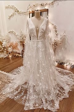 a white wedding dress on display in front of a mirror