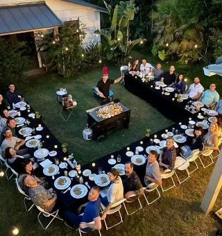 a group of people sitting around a table with plates on it in the shape of a heart