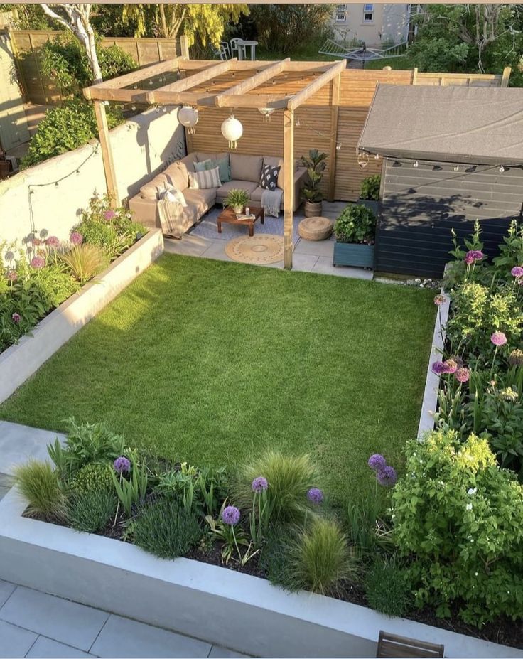 a backyard garden with grass and flowers