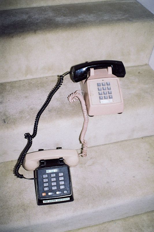 an old style telephone sitting on the stairs