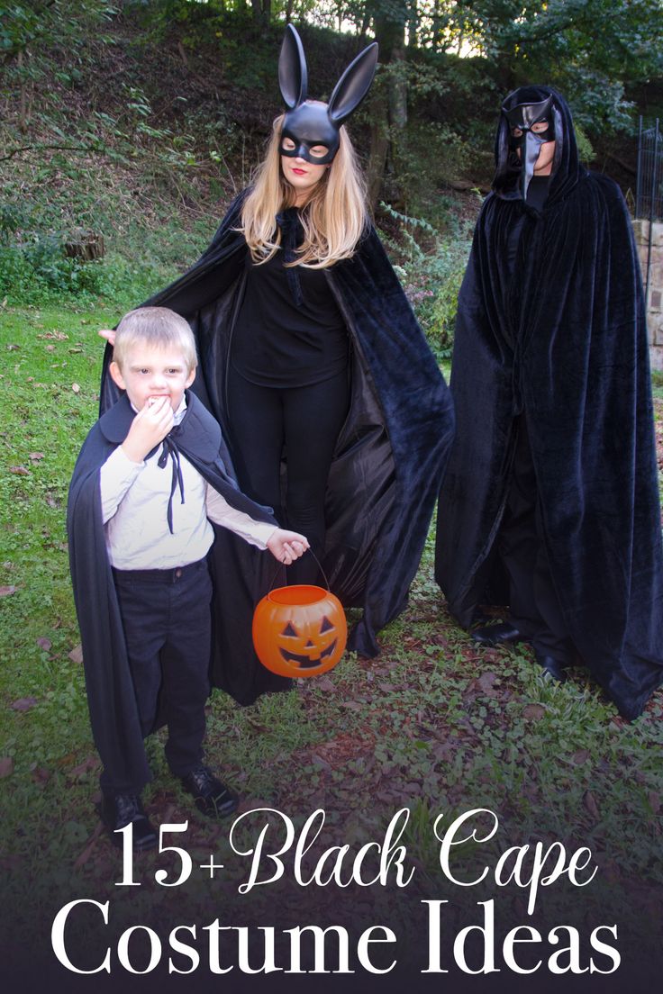 two children dressed up as black capes and one is holding a jack - o'- lantern