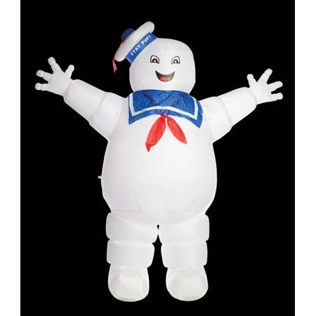 a large inflatable white character with arms and legs spread out, standing on a black background