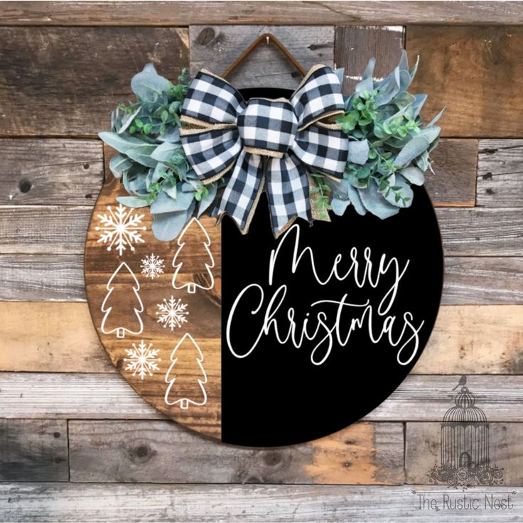 a merry christmas sign hanging on the side of a wooden wall