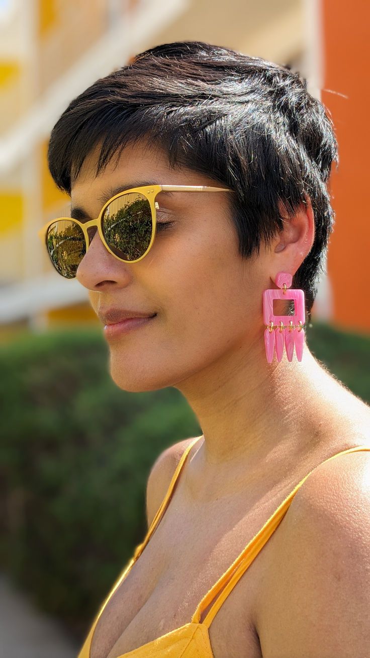 Woman wearing pink marbled tassel earrings Trendy Pink Resin Jewelry, Summer Pink Resin Jewelry, Pink Resin Jewelry For Summer, Trendy Pink Plastic Jewelry, Modern Plastic Earrings For Parties, Modern Pink Jewelry For Party, Modern Pink Party Jewelry, Modern Pink Rectangular Earrings, Trendy Pink Plastic Earrings