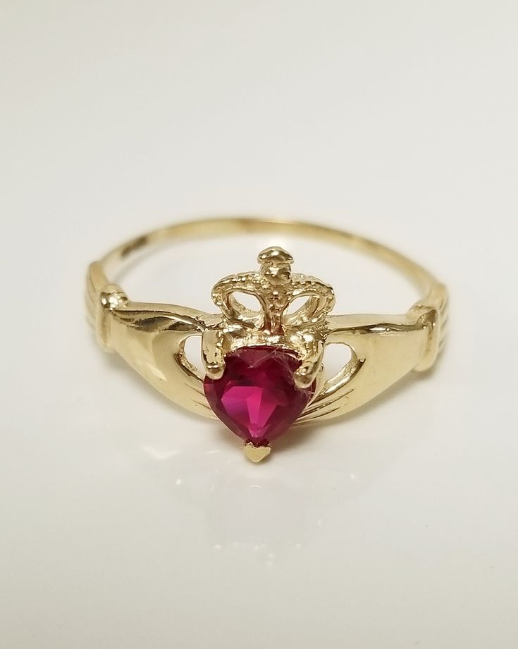 "Thanks for shopping our vintage estate store. We tend to sell well below wholesale and truly hope you enjoy all of our items. Many of the items are one of a kind, so please enjoy scrolling through the pictures and hopefully something will catch your eye. Black spots are from camera or reflections. Beautiful estate 14k gold yellow gold natural .25ct red ruby or spinel Irish Claddagh ring. Retails $389 on sale $179 Ring size: 6.75 Setting: 3/8\" Band width: 1.5mm Weight: 1.50 grams Beautiful ring Gold Heart-shaped 14k Gold Ruby Ring, Gold Heart-shaped Ruby Ring In 14k Gold, 14k Gold Heart-shaped Ruby Ring, Heart-shaped Ruby Ring In 14k Gold, Formal Gold Ruby Ring With Heart Cut, Valentine's Day Gold Ruby Ring With Prong Setting, Red Heart Birthstone Ring In 14k Gold, Red 14k Gold Heart Ring With Birthstone, Red Heart Cut Birthstone Ring In 14k Gold