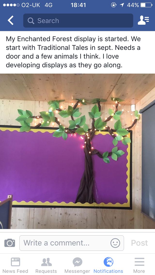 the tree is decorated with lights and paper leaves