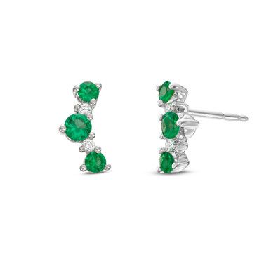 These delicate stud earrings feature emeralds totaling 0.56 carats and round brilliant cut diamonds totaling 0.05 carats. Green Brilliant Cut Diamond Earrings, Classic Green Diamond Earrings, Green Diamond Earrings With Prong Setting, Green Diamond Earrings Fine Jewelry, Fine Jewelry Green Diamond Earrings, Green Diamond Earrings In Fine Jewelry Style, Anniversary Green Diamond Earrings, Green Diamond Earrings With Diamond Accents, Green Pave Setting Fine Earrings