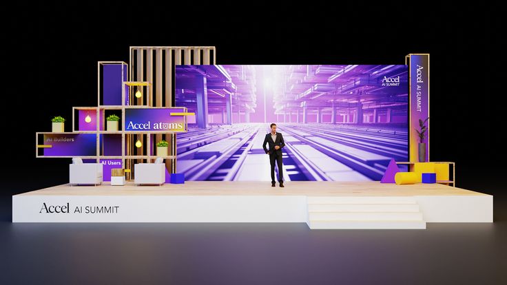 a man standing on top of a stage in front of a tv screen and shelves