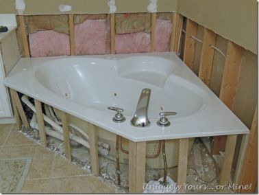 a bathtub in the corner of a bathroom under construction