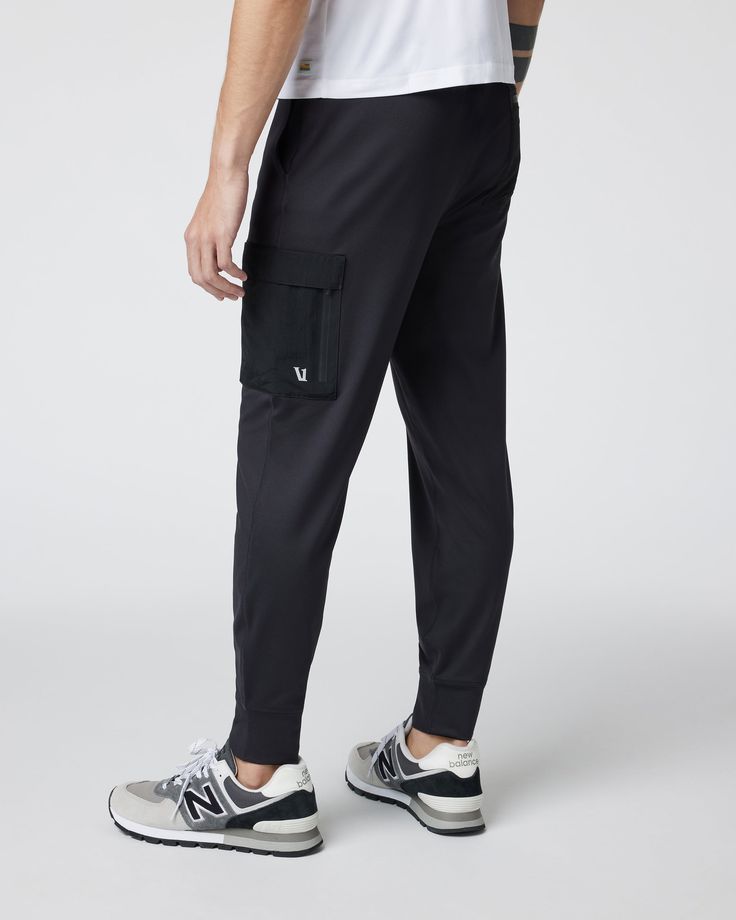 Our best-selling joggers get reinvented with added function on the Sunday Utility Jogger. This version of our classic bottoms features woven cargo pockets on the same 88% recycled performance stretch fabric you already love. | Vuori Sunday Utility Jogger Pants | Black | XL Vuori makes premium performance apparel inspired by the active Coastal California lifestyle; an integration of fitness, surf, sport, and art. Breaking down the boundaries of traditional activewear, we are a new perspective on 4-way Stretch Sportswear Joggers With Side Pockets, Urban Style Cargo Pants For Jogging, Urban Style Sports Joggers With Hip Pockets, Urban Joggers With Hip Pockets For Sports, Urban Activewear With Side Pockets For Jogging, Techwear Joggers With Side Pockets For Jogging, Urban Black Activewear With Pockets, Urban Joggers For Sports, Black Urban Activewear With Pockets