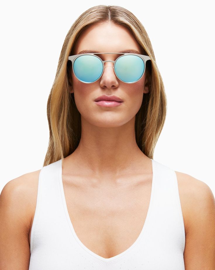 Reflect your Cali style in our mirrored Malibu shades. Featuring oval frames with a flattering double bridge design, these shades will instantly conjure a Hollywood mindset and Sunset Strip strut. The silver frame and ice blue reflective lenses are complemented by black acetone tips, while the engraved logo on both temples add some special flair. Throw these on with our Printed Ember Dress for a Santa Monica Pier vibe. Also available in: Rose Gold Details Frame Material: Metal Frame Frame Color: Trendy Silver Round Frame Sunglasses, Silver Sunglasses With Mirrored Lenses For Spring, Summer Silver Mirrored Aviator Sunglasses, Summer Silver Aviator Sunglasses With Mirrored Lenses, Silver Mirrored Cat Eye Sunglasses For Summer, Blue Round Frame Sunglasses With Mirrored Lenses, Silver Aviator Sunglasses With Mirrored Lenses For Summer, Trendy Aviator Sunglasses With Mirrored Round Frame, Trendy Sunglasses With Mirrored Lenses And Round Frame