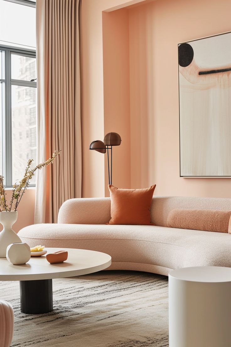 a living room with pink walls and white furniture