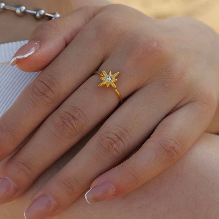 Our Eight Point Star Open Ring celebrates the beauty of life - rich or poor. Crafted with care, this stunning piece of jewelry is symbolic of our journey and the wisdom we possess along the way. Sparkling with meaning! Metal: 18K Gold over Stainless Steel Hypoallergenic & Water Resistant Size: Adjustable Fine Jewelry Star Shaped Rings For Gifts, Fine Jewelry Star-shaped Ring For Gift, Gold Celestial Crystal Ring With Birthstone, Gold Celestial Birthstone Ring For Anniversary, Gold Celestial Birthstone Promise Ring, Star-shaped Birthstone Promise Ring, Celestial Gold Crystal Ring With Birthstone, Star-shaped Yellow Gold Rings As Gifts, Yellow Gold Spiritual Promise Ring