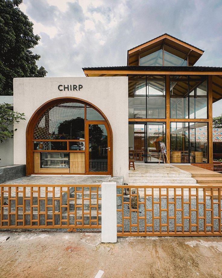 the front entrance to chirp, a modern restaurant with wooden accents and glass doors