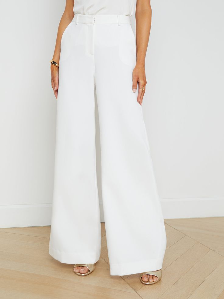 A modern, tailored wide-leg pant in white. Flatteringly proportioned, high-rise style hugs through contoured waistband to hips, then falls in a wide, flared leg to hem. Includes belt loops, and side seam and back welt pockets. Front zip fly closure with hidden hook-and-bar closure. | L'AGENCE Gavin Wide-Leg Pants In White Great Neck New York, Parisienne Chic, Spring Suit, High Rise Style, Summer Suits, Wide Leg Pant, Tailored Suits, Denim Flares, Denim Coat