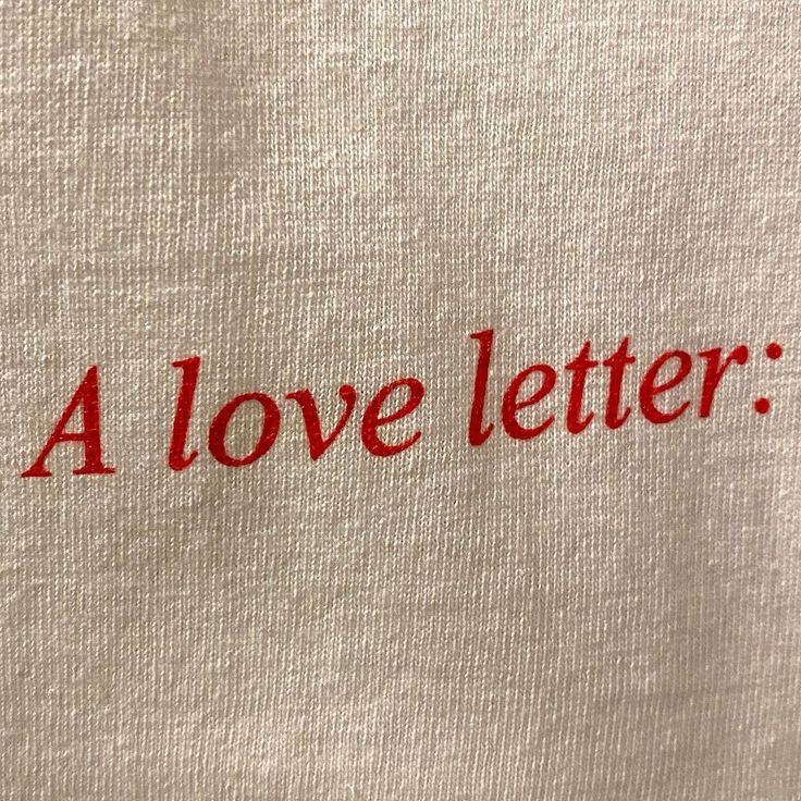 a white t - shirt with the words a love letter on it's chest