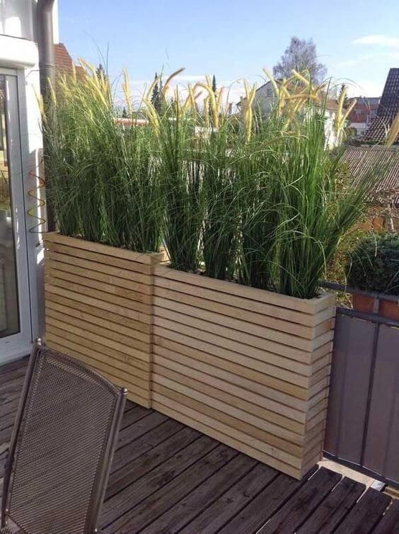 a wooden planter sitting on top of a wooden deck