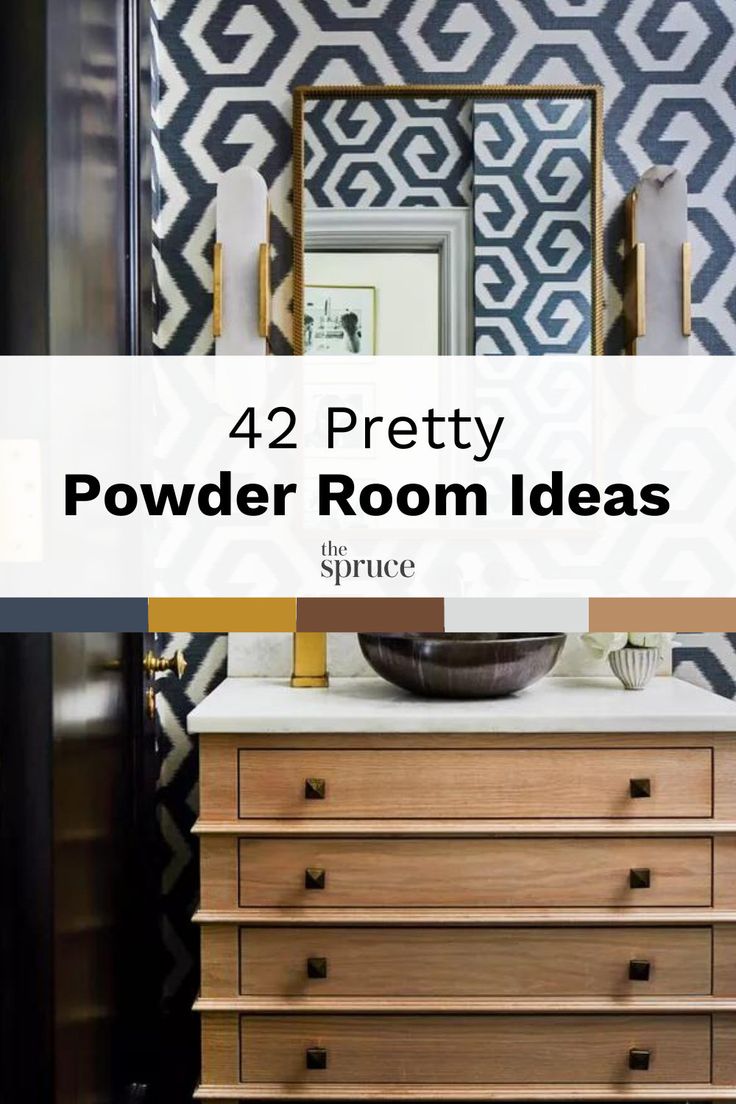 a bathroom with black and white wallpaper, wooden drawers and a mirror over the sink