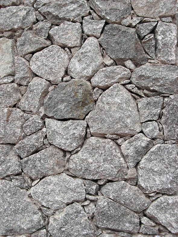 a stone wall made up of small rocks