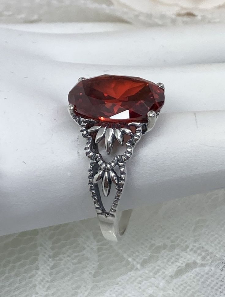 "Red Garnet CZ Ring Ace-Oval Design#92 Custom Made I now offer this lovely Gothic/Renaissance inspired ring in sterling silver. This gorgeous ring is set with a flawless Red Garnet Cubic Zirconia gemstone. The full cut 5ct oval cut gemstone is 14mm (9/16th of an inch) Long by 10mm Wide (3/8th\"). The ring sits 7mm off the finger. The inside of the band Is marked 925 for sterling. Notice the beautiful leaf-like design of the filigree setting. A ring box is included for safe keeping. Feel free to Classic Marquise Topaz Ring For Gift, Formal Oval Crystal Gemstone Ring, Oval Topaz Ring For Formal Occasions, Classic Crystal Birthstone Ring For Formal Occasions, Elegant Oval Rings With Stone Setting, Formal Oval Crystal Ring, Formal Oval Ruby Ring With Stone Setting, Victorian Red Oval Filigree Ring, Classic Oval Crystal Ring With Stone Setting