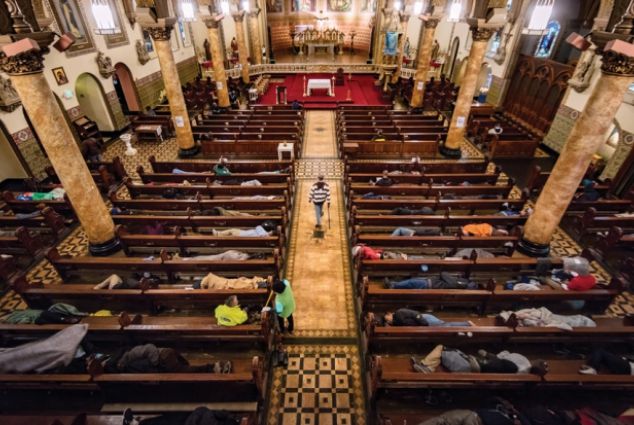 an overhead view of a church with pews and people laying on the floor in it