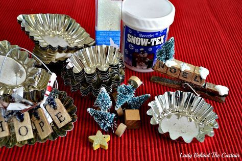 some christmas decorations are sitting on a red tablecloth with snowflakes and wine corks