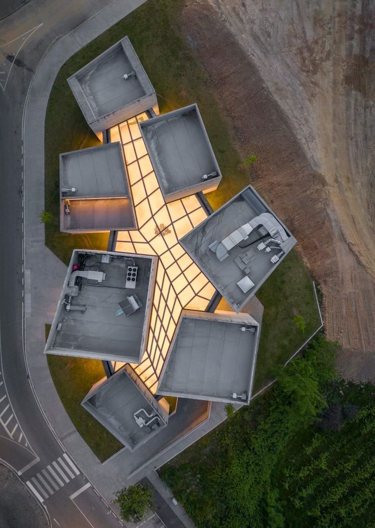 an aerial view of a building with lights on it's sides and the roof